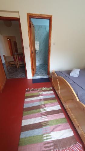 a room with a bed and a rug on the floor at Tayda Guest House in Azilal