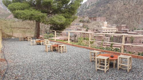 a group of tables and chairs on top of a mountain at Tayda Guest House in Azilal