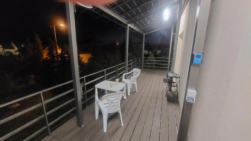 a balcony with a table and chairs on a building at Hotel Konty in Kąty Opolskie