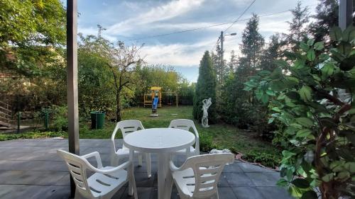 a white table and chairs on a patio at Hotel Konty in Kąty Opolskie