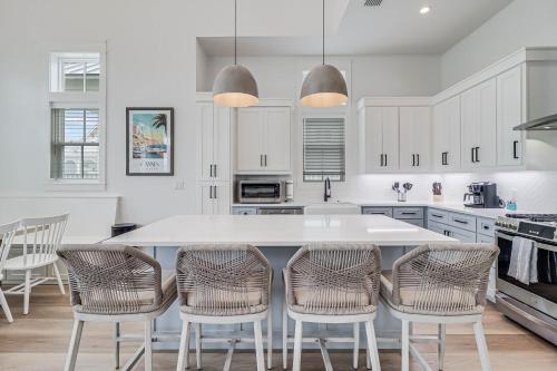 a kitchen with a large white table and chairs at La Belle Vue 120 BAR in Mustang Beach
