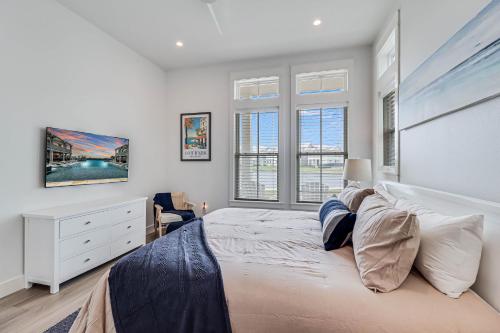 a bedroom with a bed and a dresser and windows at La Belle Vue 120 BAR in Mustang Beach
