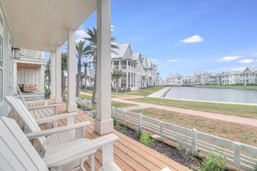 a porch with two chairs and a view of the water at La Belle Vue 120 BAR in Mustang Beach