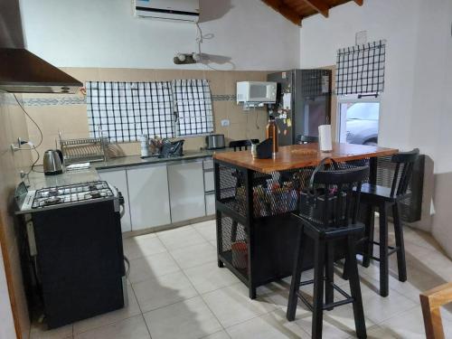 una cucina con un bancone, un tavolo e una stufa di MAPU PATAGONIA a Puerto Madryn