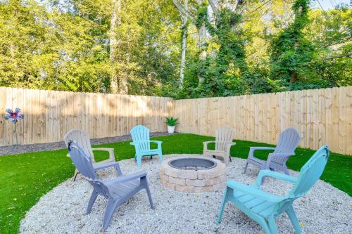 a group of chairs around a fire pit in a yard at Greenville Escape with Deck and Fire Pit! in Greenville
