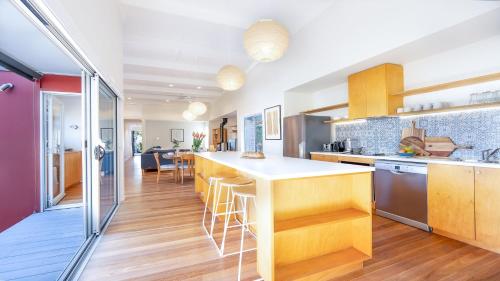 a kitchen with wooden cabinets and a counter top at Buwarla House in Currarong
