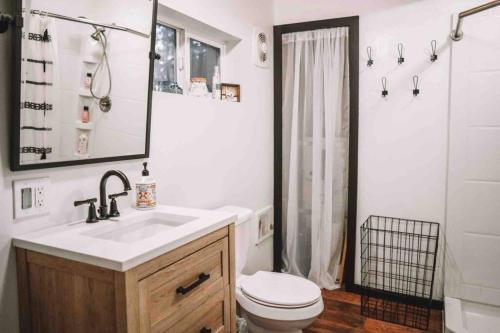 a bathroom with a sink and a toilet and a shower at Aframe of Mind Packwood in Packwood