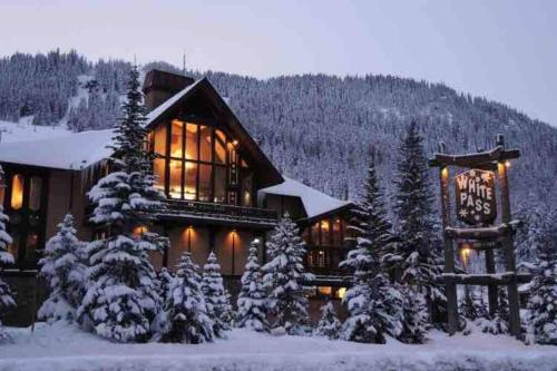 a log cabin in the snow with snow covered trees at Aframe of Mind Packwood in Packwood