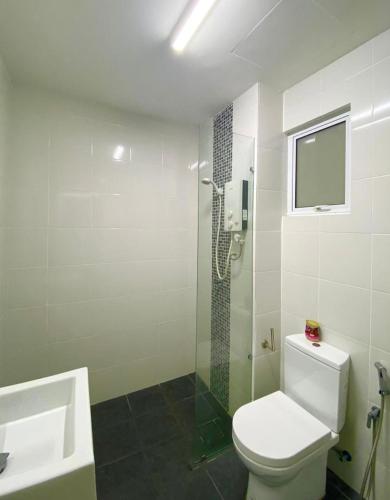 a bathroom with a shower and a toilet and a sink at 2 Bedrooms Suites at Mesahill Nilai with Mall by D'KAY HOMES, near USIM KLIA in Nilai