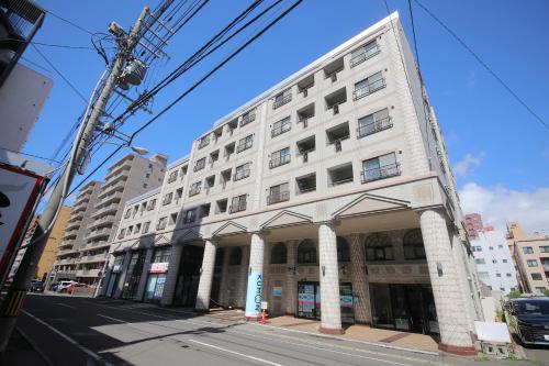 a white building on the corner of a street at ノーザンヒルズ南6条 in Sapporo