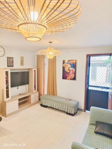 a living room with a couch and a television at Staycation in San Pablo laguna in San Pablo