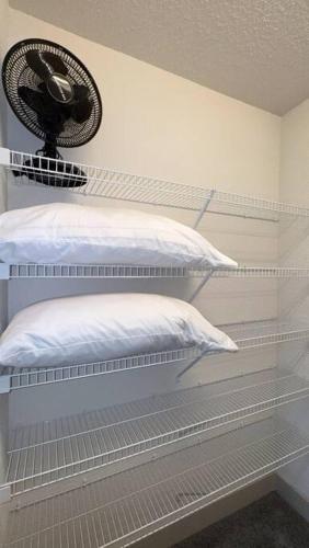 a room with two beds and a fan on the wall at Beautiful Condo on Riverwalk King Suite w Free Parking Pet Friendly Centrally Located on the Riverwalk in San Antonio