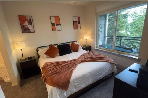 a bedroom with a bed and a large window at Beautiful Condo on Riverwalk King Suite w Free Parking Pet Friendly Centrally Located on the Riverwalk in San Antonio