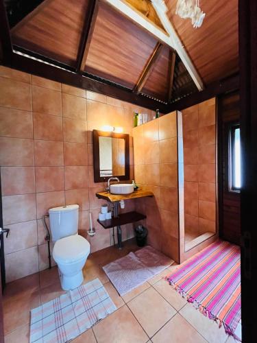 a bathroom with a toilet and a sink at Villa Happy Hour in Atiha