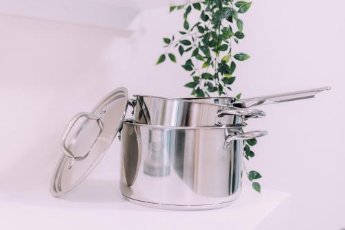 a metal bucket with a plant in it at Minimalist Loft Namba Compact Studio with a 24-hour Gym MA401 in Osaka