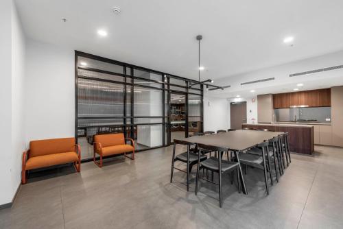 a dining room with a table and some chairs at Penthouse Apartment in Belconnen in Belconnen