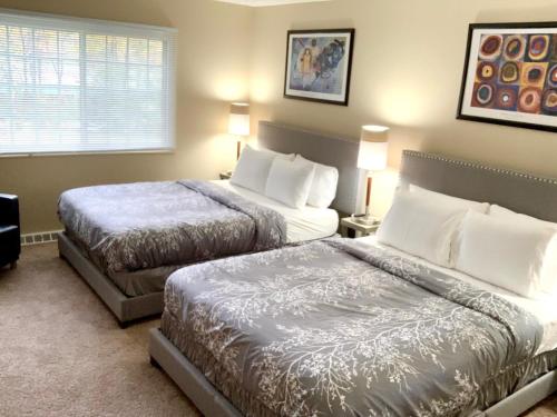 a hotel room with two beds and a window at The House Hotels- E. Turkeyfoot #1 in Akron