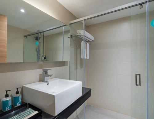 a bathroom with a white sink and a shower at Greenpark Visakhapatnam in Visakhapatnam