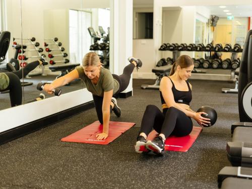 two women laying on mats in a gym at Parmelia Hilton Perth in Perth