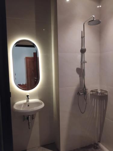 a bathroom with a sink and a mirror at Sujiwa Ubud Hotel & Villa in Ubud