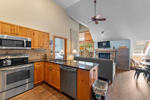 a kitchen with stainless steel appliances and a living room at Expedition 8631 in Keystone
