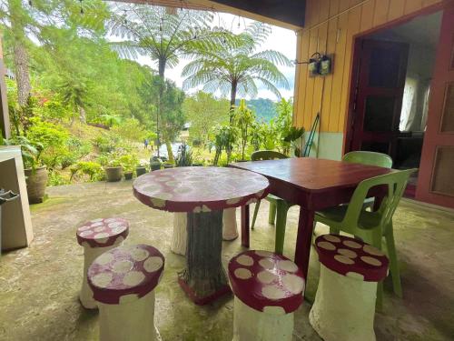 a table and chairs sitting on a patio at SU Valley Lodge in Bundu Tunan