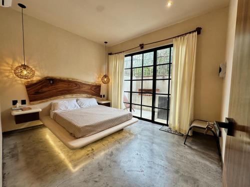 Ένα ή περισσότερα κρεβάτια σε δωμάτιο στο Casa Kobaab Tulum