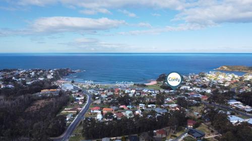 an aerial view of a city with a hot air balloon at 2-Bed Beach Haven with Garden & Alfresco Dining in Malua Bay