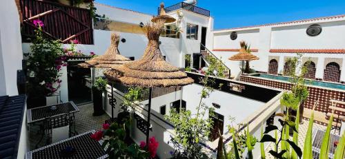 a courtyard of a building with flowers and plants at Dar Najat in Marrakech