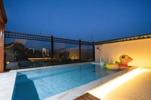 a swimming pool with a rubber duck sitting on top of a building at Gubei Water Town Landscape Villa in Miyun