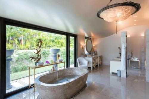 a large bathroom with a large tub in the middle at Luxury Villa in La Punta Estates, Enjoy 3,000 Usd Credit for Thanksgiving in Punta Mita