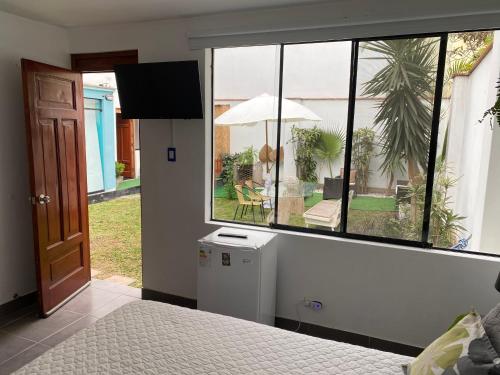 a bedroom with a bed and a large window at Hermosa habitación independiente cerca a Miraflores in Lima