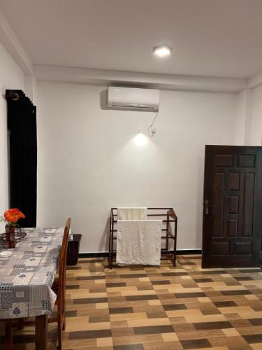 a room with a table and chairs and a door at Siri Villa Habaraduwa in Habaraduwa