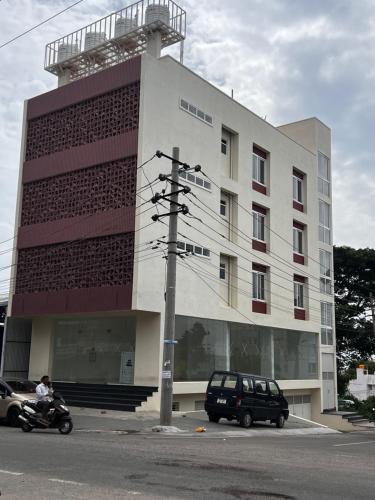 a building with a car parked in front of it at SAHARHOMEstay O3 in Mysore