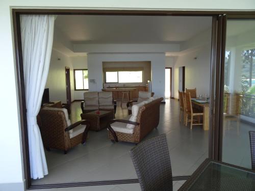 a living room with chairs and a dining room at Sailfish Beach Villas in Anse a La Mouche