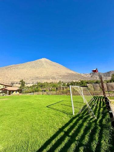 a soccer field with a goal in front of a mountain at Cabaña con tinaja privada in Vicuña