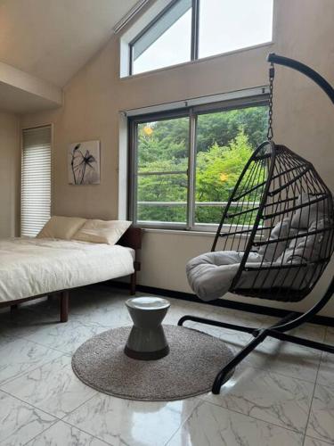 a room with a swing and a bed and a window at 那須小結 Fabulous House 一棟貸BBQ in Nasu