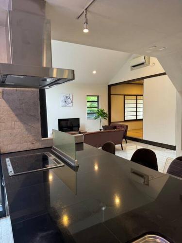 a living room with a glass table and a couch at 那須小結 Fabulous House 一棟貸BBQ in Nasu