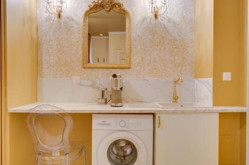 a bathroom with a sink and a washing machine at Compact City-Centre Studio with Parking and Wi-Fi in Bordeaux
