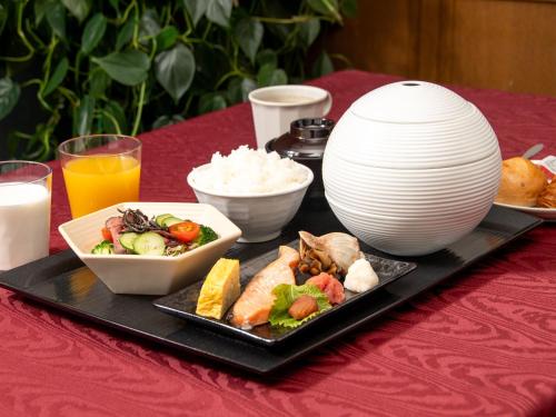 a tray with a plate of food on a table at R Hotels Inn Hokkaido Asahikawa in Asahikawa