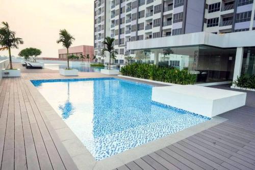 a swimming pool in the middle of a building at Near Ferry Terminal - Lovely 2 Bedroom Condo - Harbourbay Residences - 0608 in Tanjunguma
