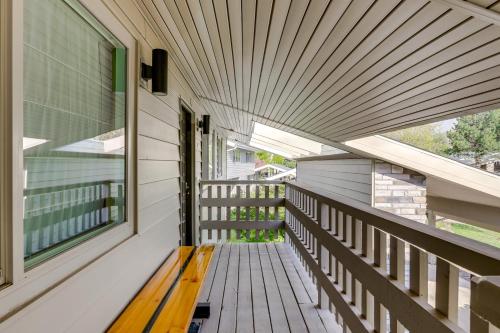 a wooden bench on the porch of a house at Carbondale Condo with Balcony and On-Site Fly Fishing! in Carbondale