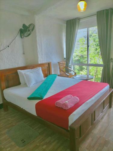 a bedroom with a bed with two towels on it at Green view Kandy in Kandy