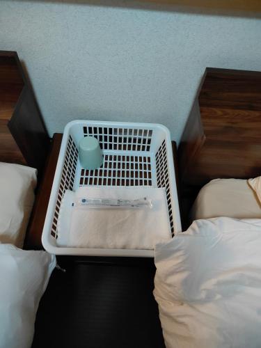 a room with two beds and a basket on the floor at 4BRHouse near Nikko Suginami Cedar Avenue in Nikko