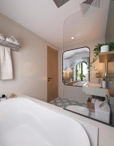 a bathroom with a white bed and a mirror at Plum Village Moc Chau in Mộc Châu