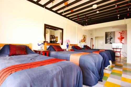 a group of beds in a room at Minamiboso Asian Garden Villa Shirahama in Minamiboso