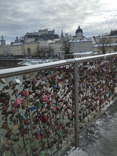 a fence filled with lots of locks on a bridge at Guggenthaler Gipfelblick in Guggenthal
