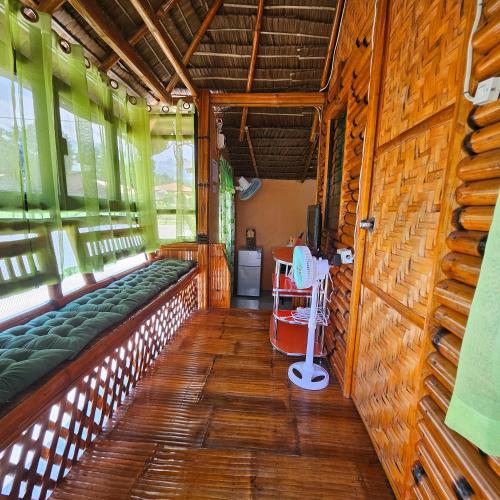 a train car with green seats and wooden walls at Casa Celine Dumaguete in Dumaguete