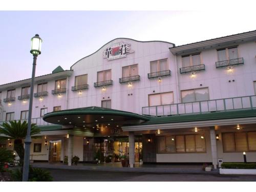 a large white building with a sign on it at Hitoyoshi Onsen Hotel Hananoshou - Vacation STAY 40096v in Hitoyoshi
