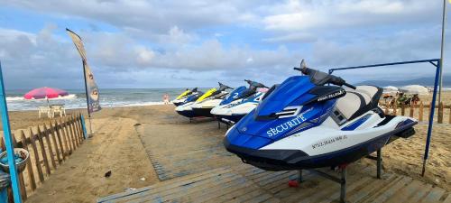 a row of boats lined up on the beach at SOLEIL DE MARTIL in Martil